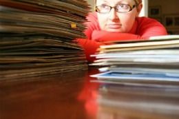 woman behind pile of files
